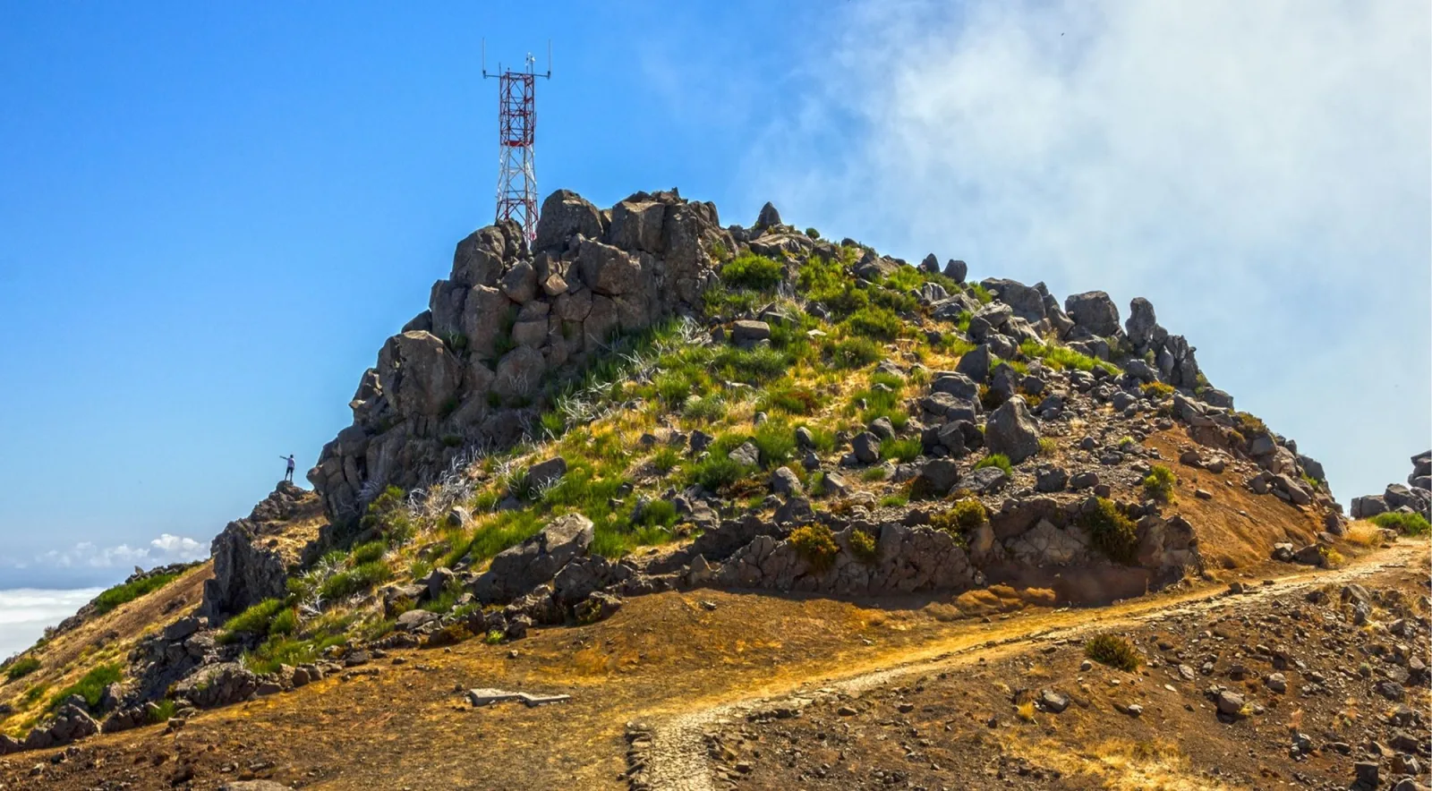The rocky summit crown of Pico do Arieiro with its weather mast