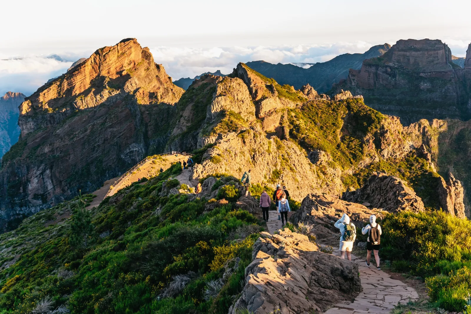 The jagged Pico do Arieiro ridge lit gold at sunrise above the cloud layer