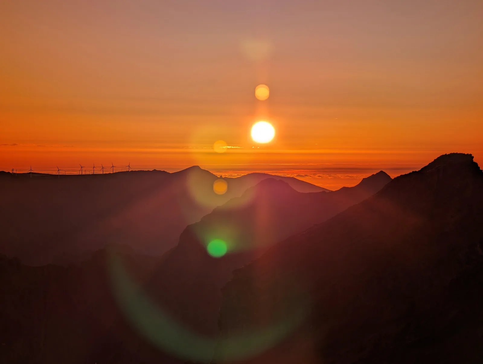 The sun dropping towards the peaks at Pico do Arieiro