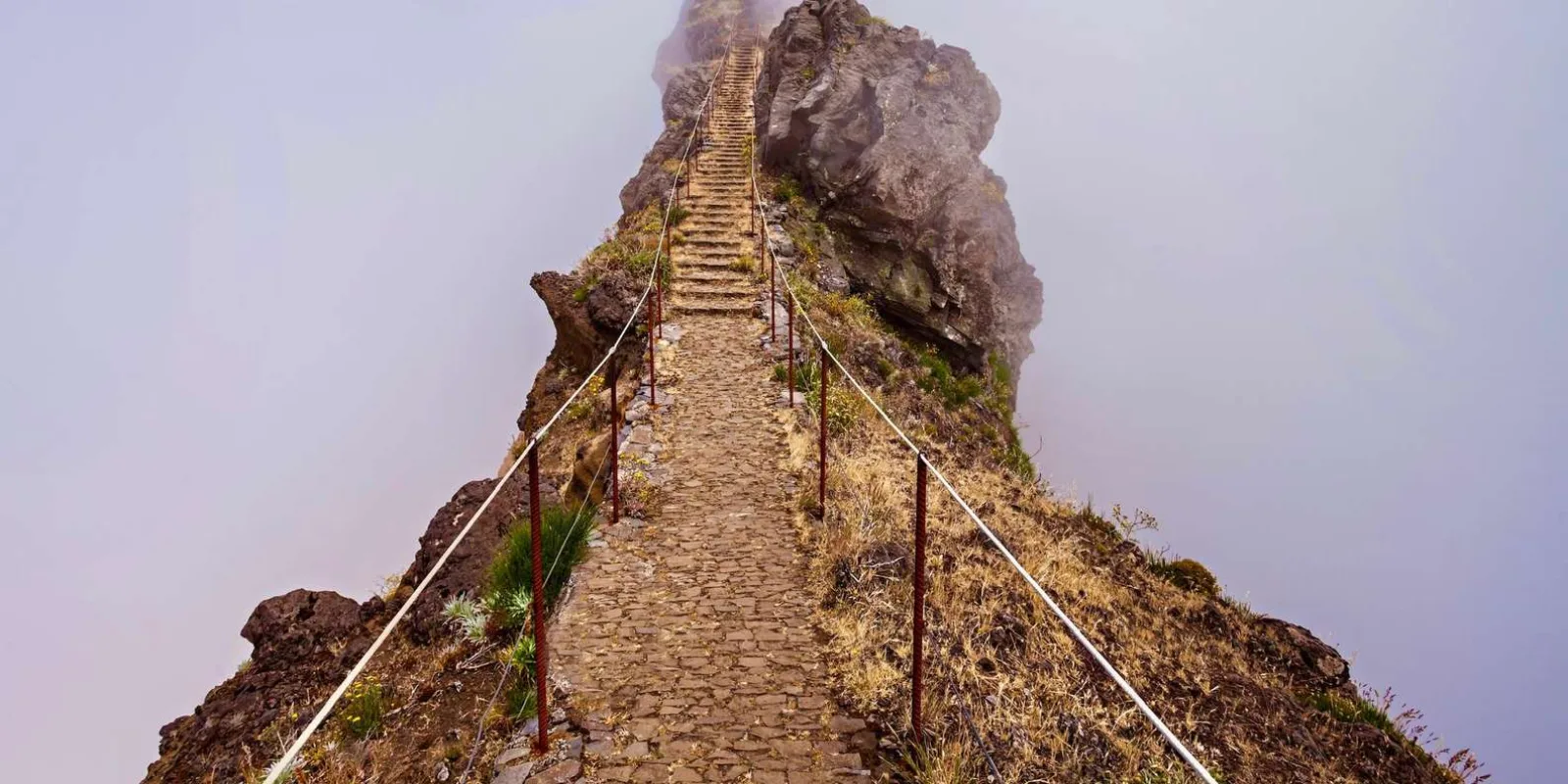 The stone stairway climbing to a rock buttress on the PR1